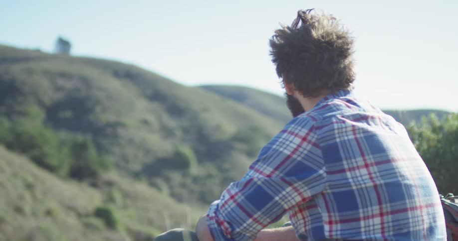 A hiker rests on the mountain