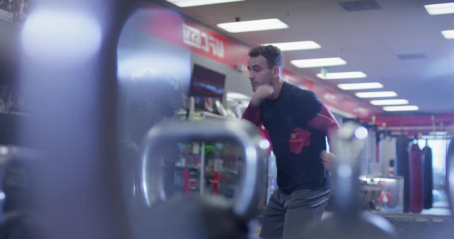A man is shadowboxing in the gym