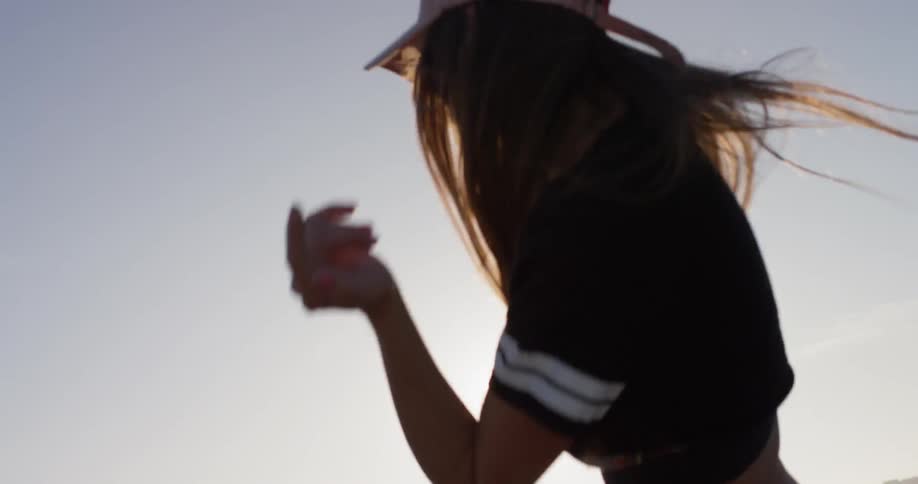 A woman dances on the building rooftop