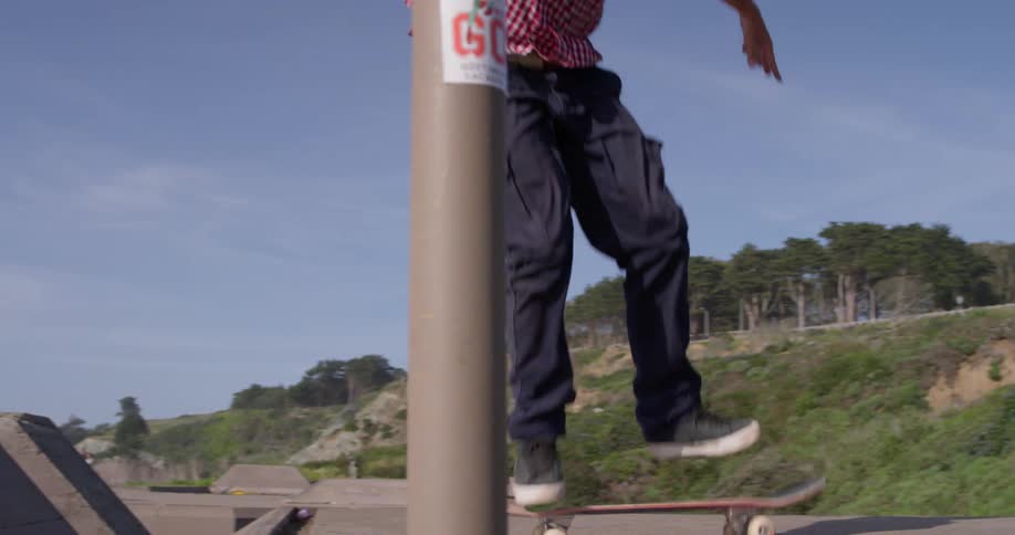 A skateboarder runs and jumps onto the board
