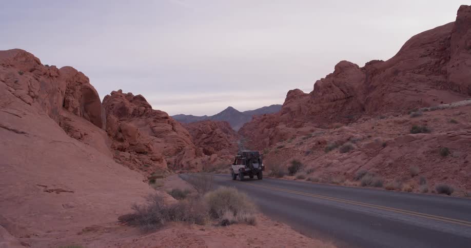 A vehicle travels in a desert