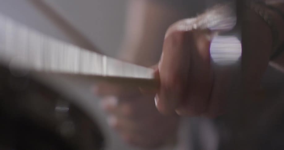 A drummer is playing drums indoors in daylight