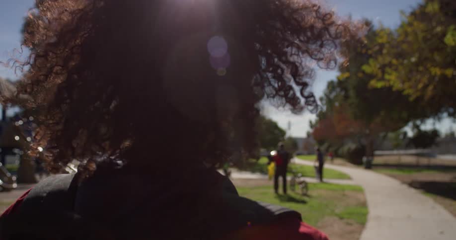 Man wearing sunglasses walks on a trail in the park
