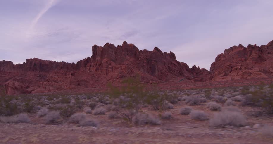 Red rock formations cover a desert landscape