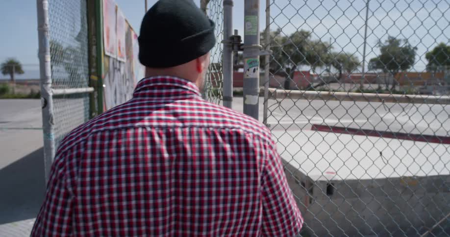 A man enters an outdoor skatepark
