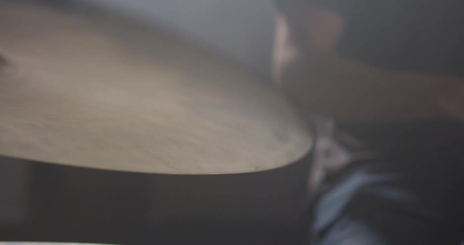 Man is playing the cymbal and drums