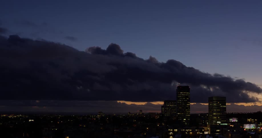 The storm clouds roll over the city at dawn