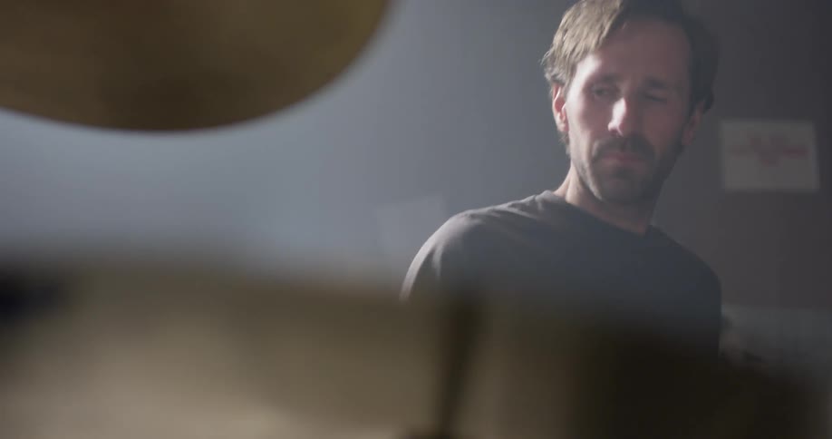 A drummer plays on the drum kit