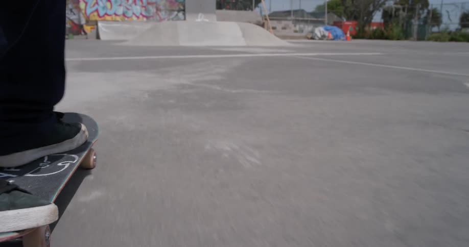 A man skateboards at an outdoor skatepark