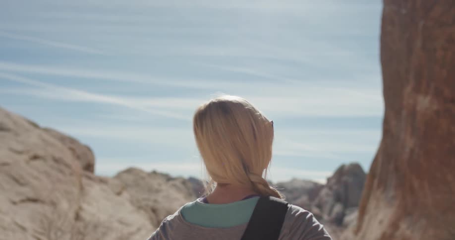 A woman hikes in a desert