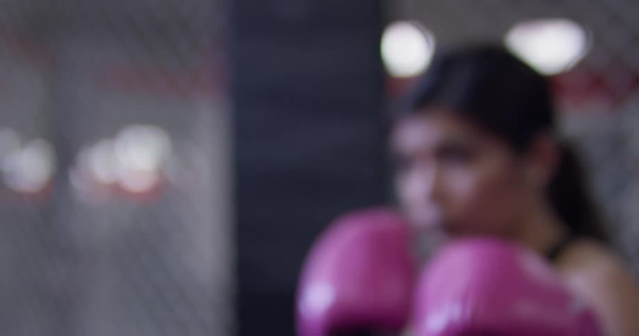 Woman hits a punching bag in a gym