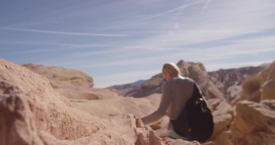 A woman hikes alone in a desert