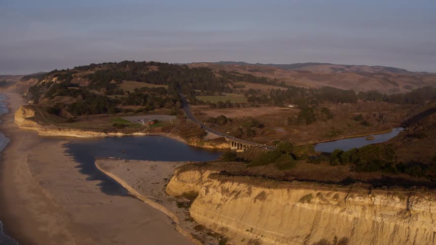 Water flows to shore at sunset