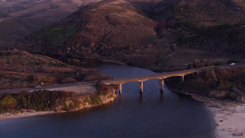 Cars travel over the bridge below