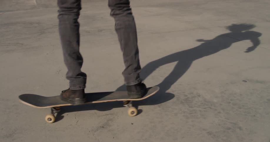 A man does a kick flip on a skateboard