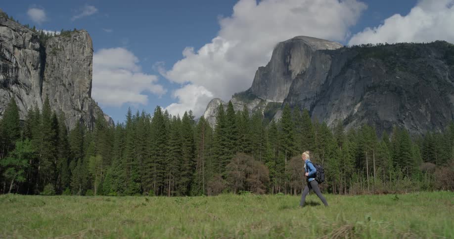 A woman hikes near the mountains