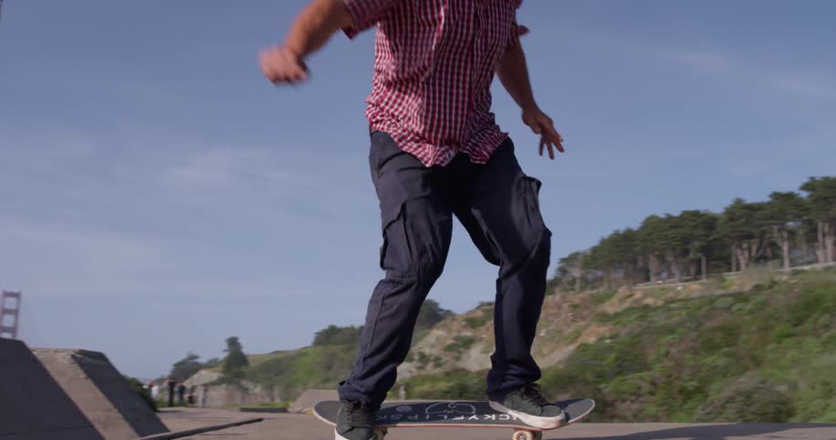 A skateboarder is leaping up a ramp and trying to land on his skateboard on a sunny day