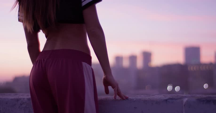 Woman stands looking at skyline