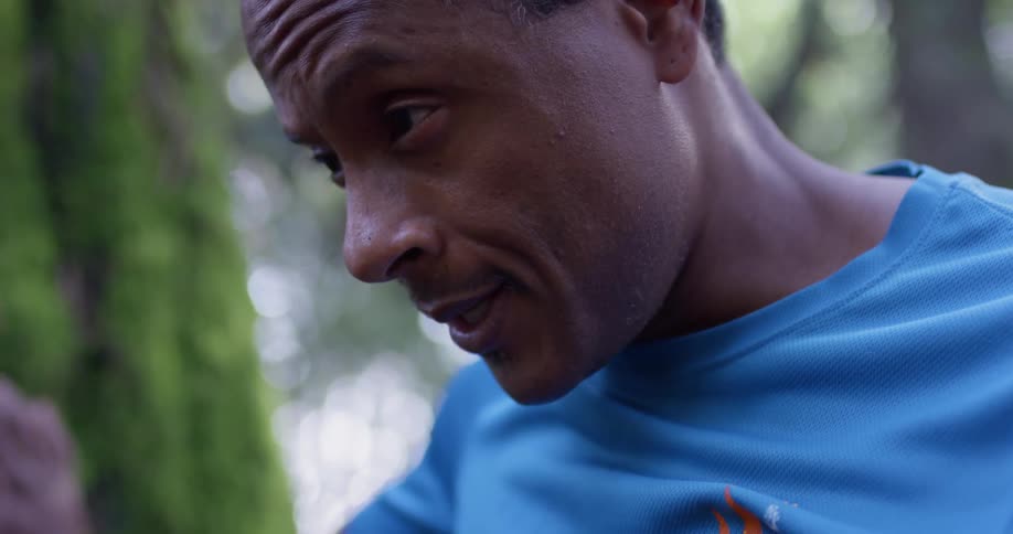 Man stands with hand against tree