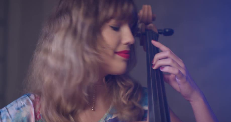Woman plays the cello and nods her head
