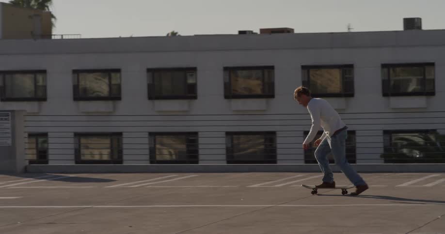 Man skateboarding in urban parking lot
