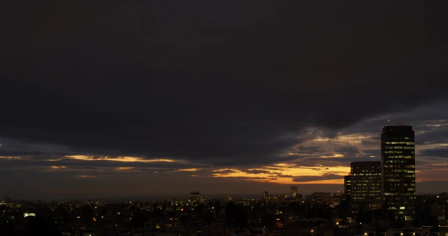Heavy clouds roll over the city at dawn