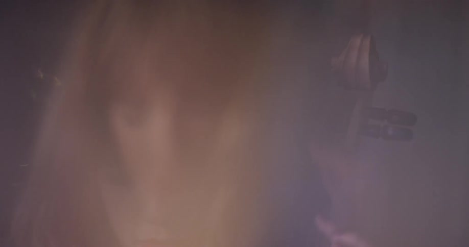 Woman plays a cello in blurry light