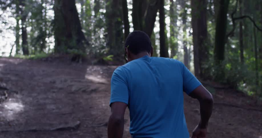 The man slowly walks up the hill