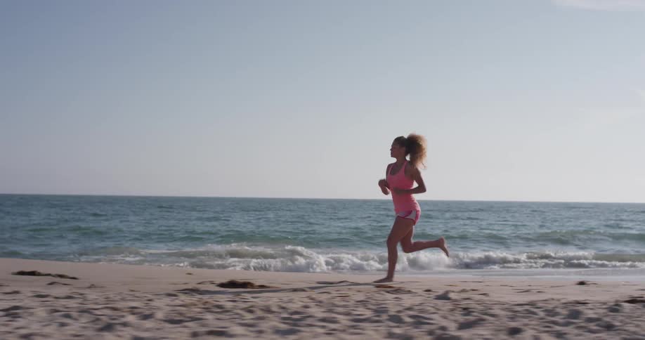 A woman jogs on the beach