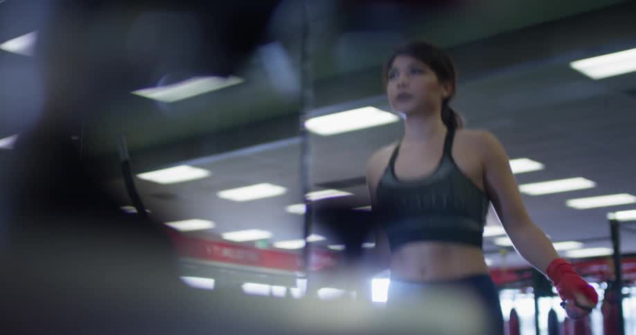 A woman jumps rope in a gym