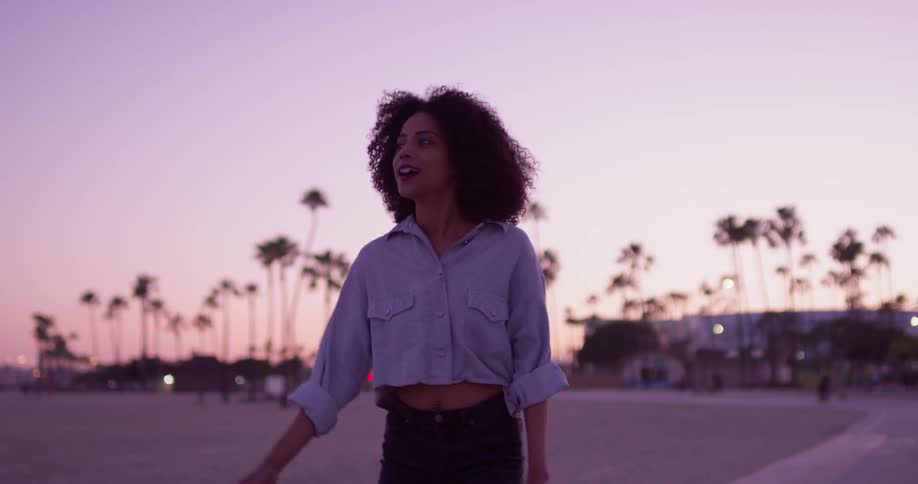 A woman is skating at sunset