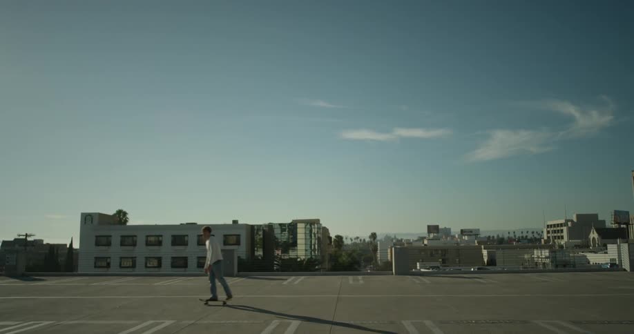 Man skateboarding in urban parking lot
