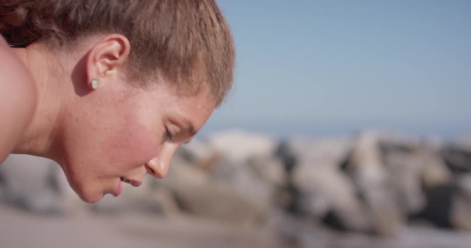 A woman leans over to catch her breath