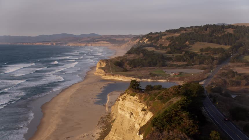 Ocean waves flow to a sandy shore