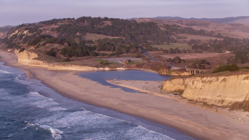 The tide rolls in towards the shore
