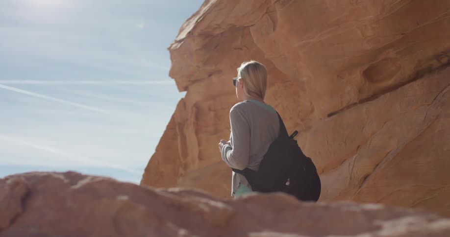 A woman hikes in a desert