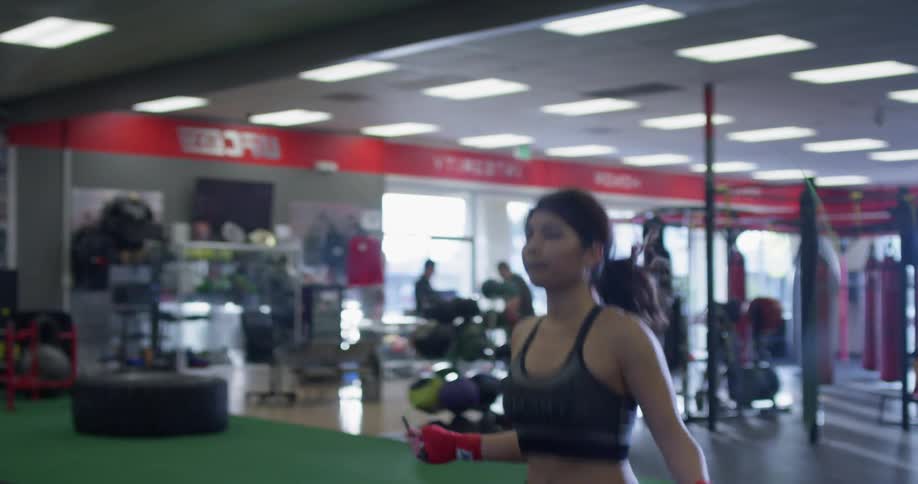 A woman jumps rope in a gym