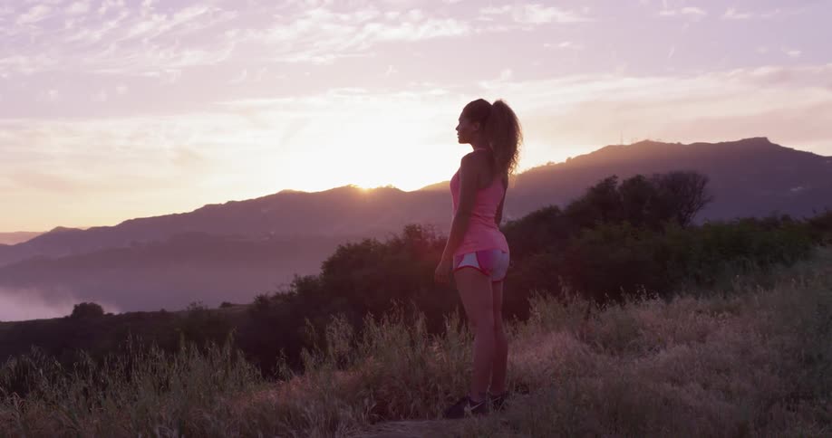 A woman jogs up to the hilltop