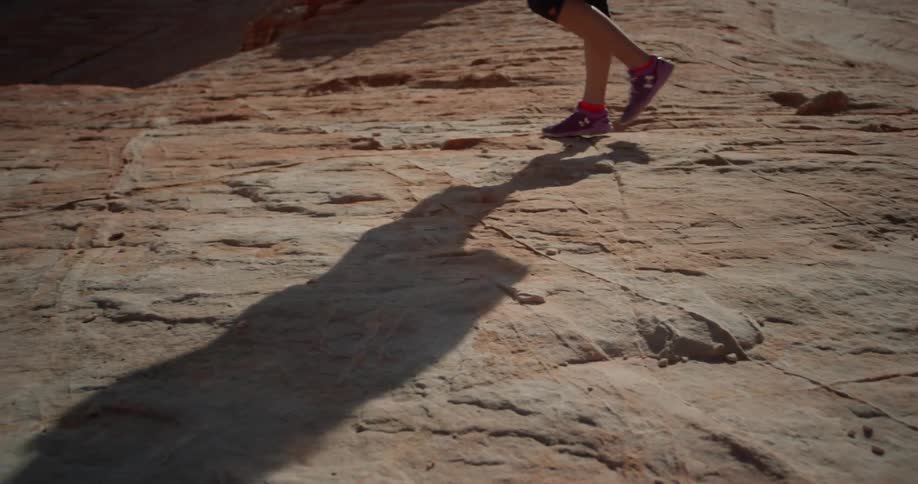 Person walks over rocky desert terrain