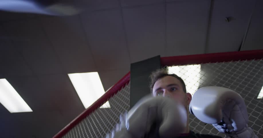 A man is punching the speed bag