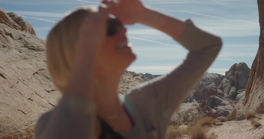 A woman hikes alone in a desert