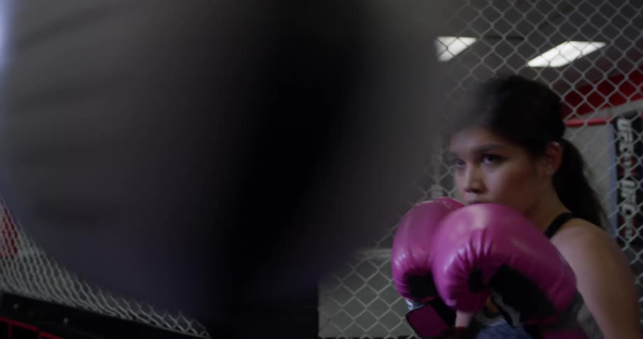 A woman trains on a punching bag
