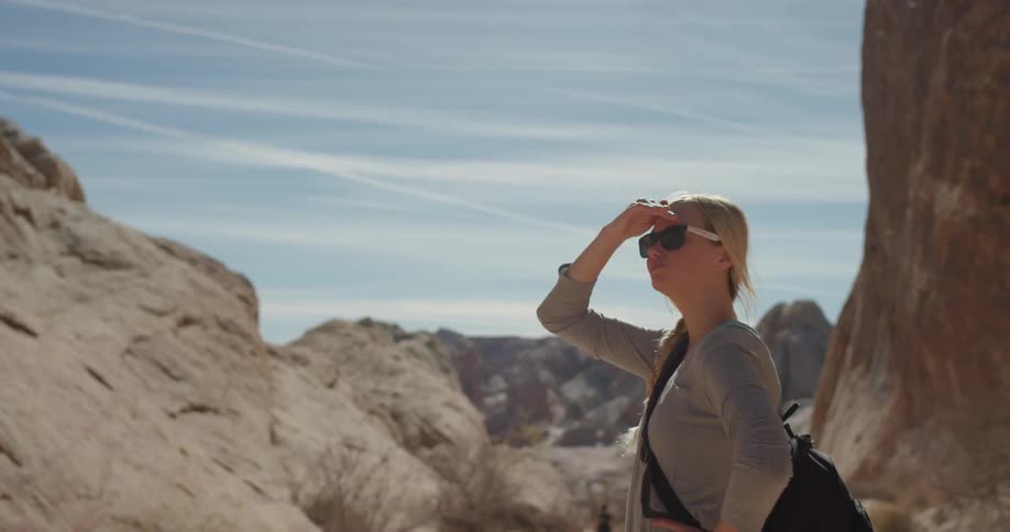 A woman looks out towards the rock formations