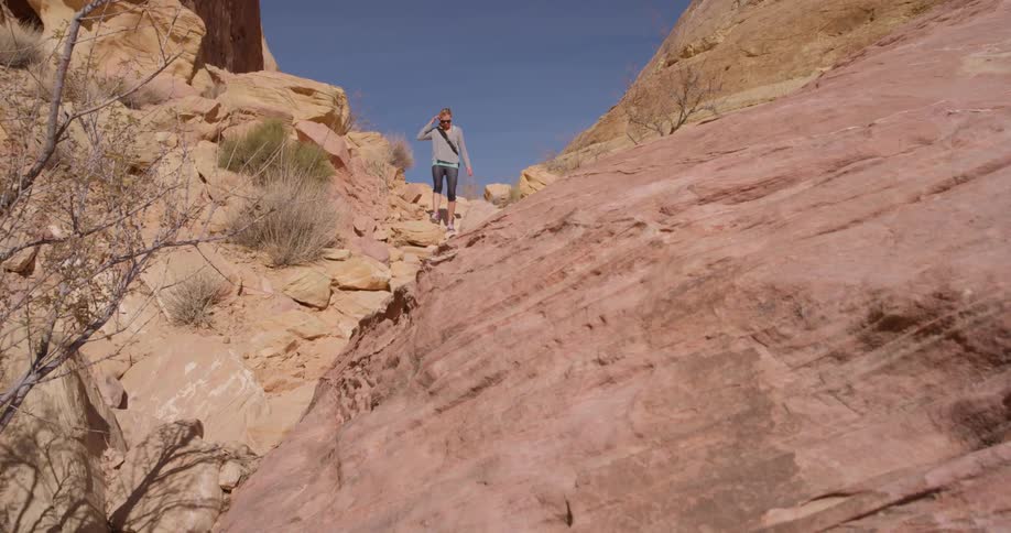A woman hikes alone in a desert