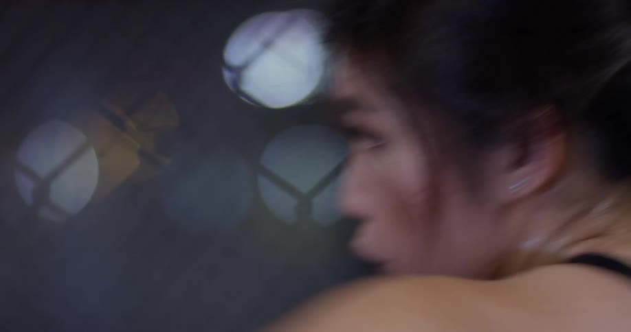 A female boxer punches the air