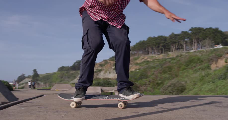 Man runs and jumps on skateboard
