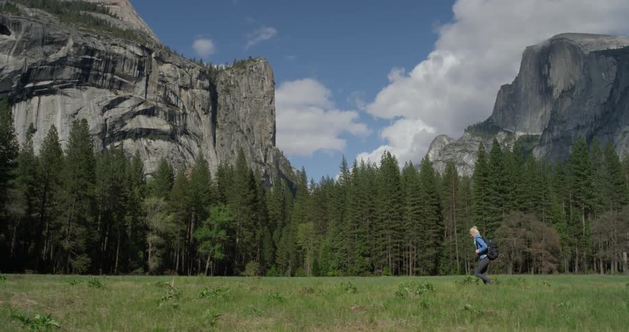A woman hikes near the mountains
