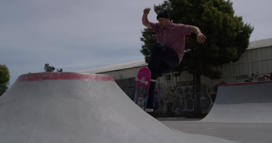 A skater rides up a ramp in a skate park