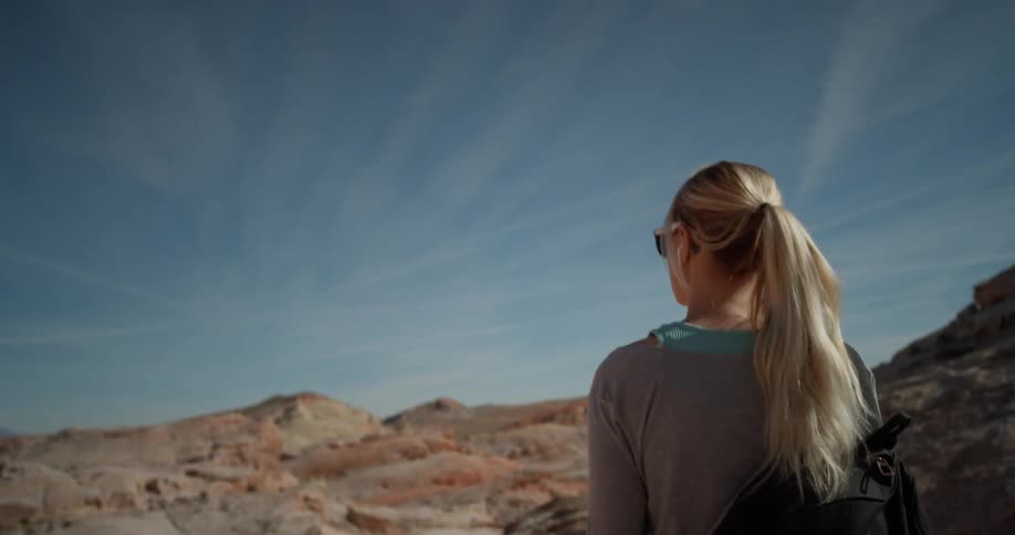A woman hikes in a desert