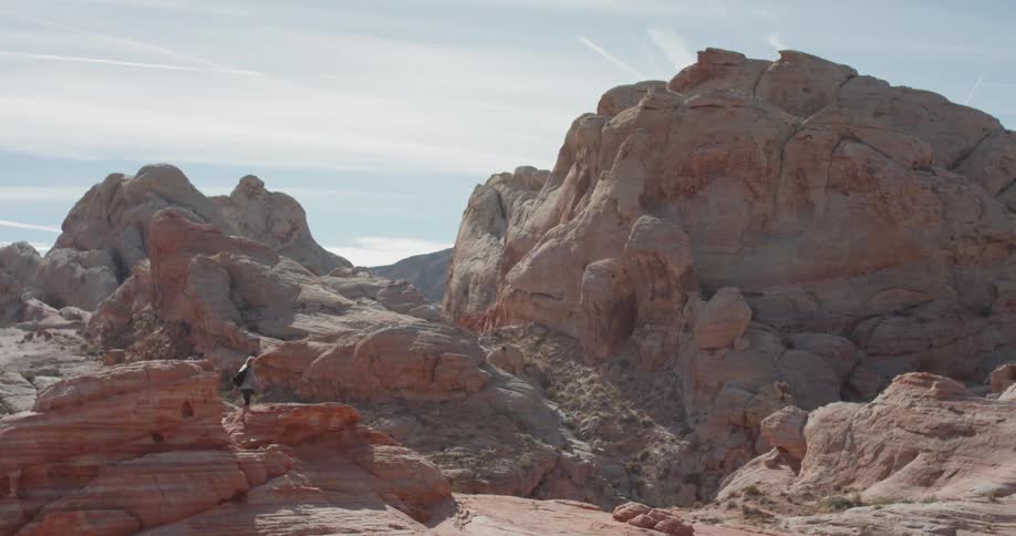A woman hikes on the rocks